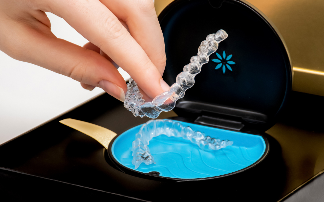 dental patient grabbing Invisalign clear aligners out of case