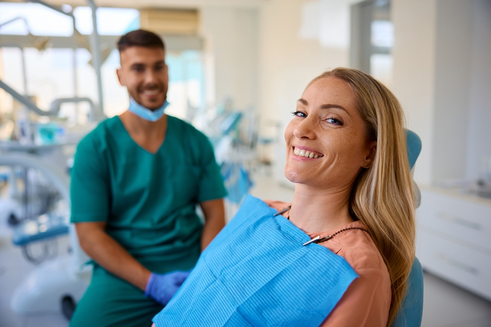 A dentist discussing bone graft options with a patient in a modern dental office